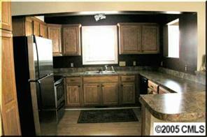 406 Stutts Road Mooresville, NC 28117 - Photo 3 of 8 a kitchen with stainless steel appliances granite countertop a refrigerator a stove and a sink