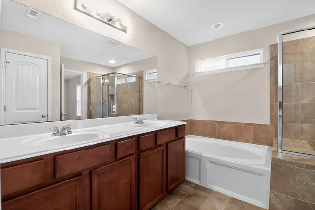a bathroom with a shower and a sink