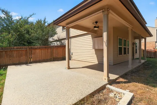 a view of a porch with a table and chairs