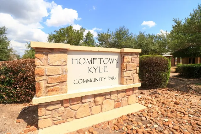 a backyard of a house with a large tree