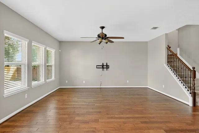 a view of empty room with wooden floor