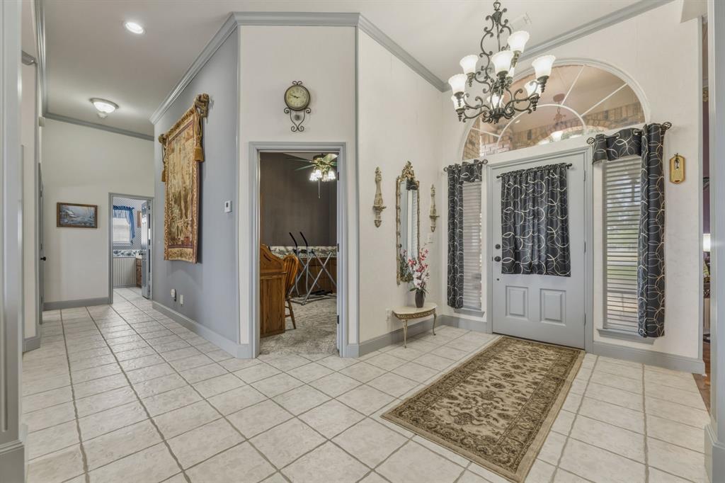 130 Blazek Road Alma, TX 75119 - Photo 8 of 34 a view of a hallway with wooden floor and a chandelier