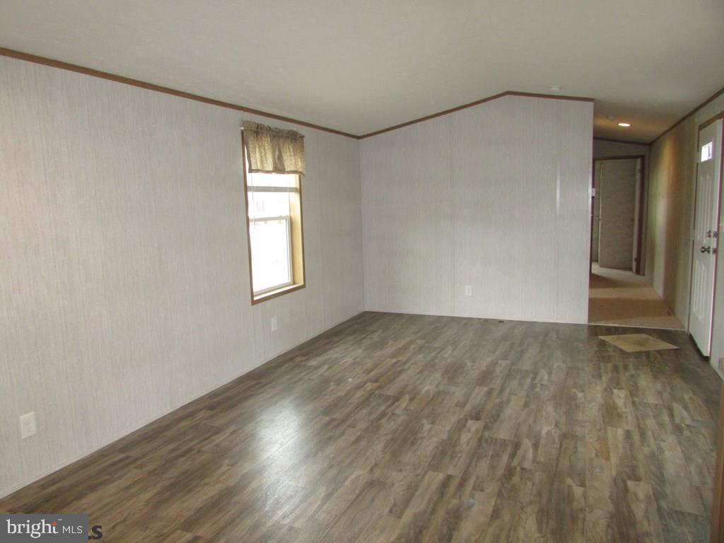 382 Hawk Lane Julian, PA 16844 - Photo 3 of 16 an empty room with wooden floor and windows