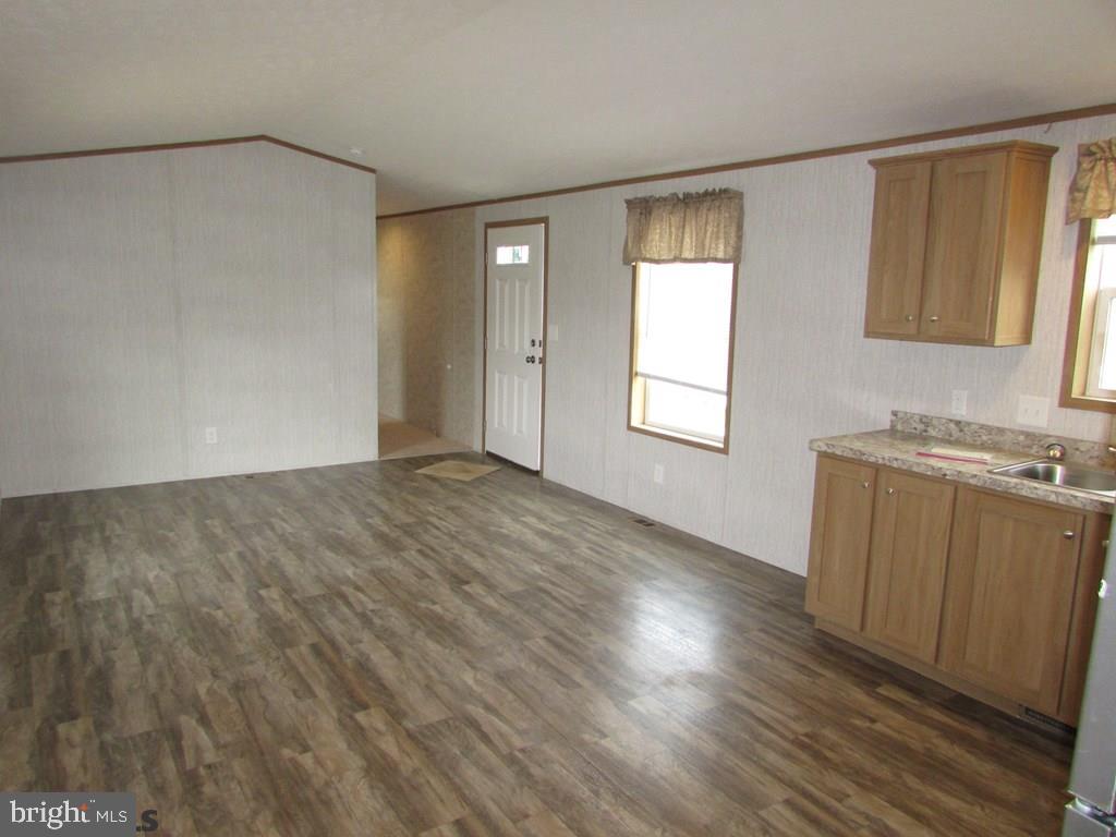 382 Hawk Lane Julian, PA 16844 - Photo 4 of 16 an empty room with wooden floor and windows
