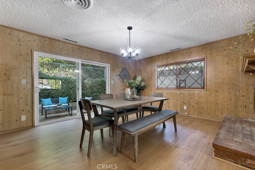 4775 Regalo Road Woodland Hills, CA 91364 - Photo 12 of 42 a view of a dining room with furniture window and wooden floor