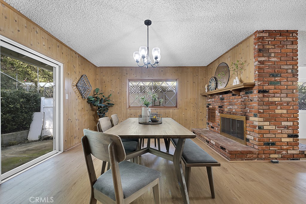 4775 Regalo Road Woodland Hills, CA 91364 - Photo 13 of 42 a view of a dining room with furniture window and wooden floor