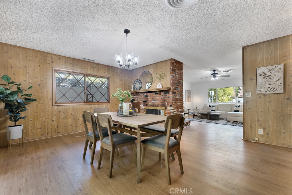4775 Regalo Road Woodland Hills, CA 91364 - Photo 14 of 42 a view of a dining room with furniture wooden floor and chandelier