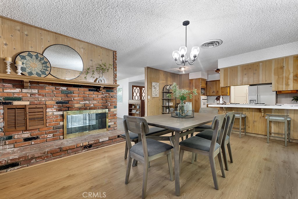 4775 Regalo Road Woodland Hills, CA 91364 - Photo 15 of 42 a view of a dining room with furniture and wooden floor