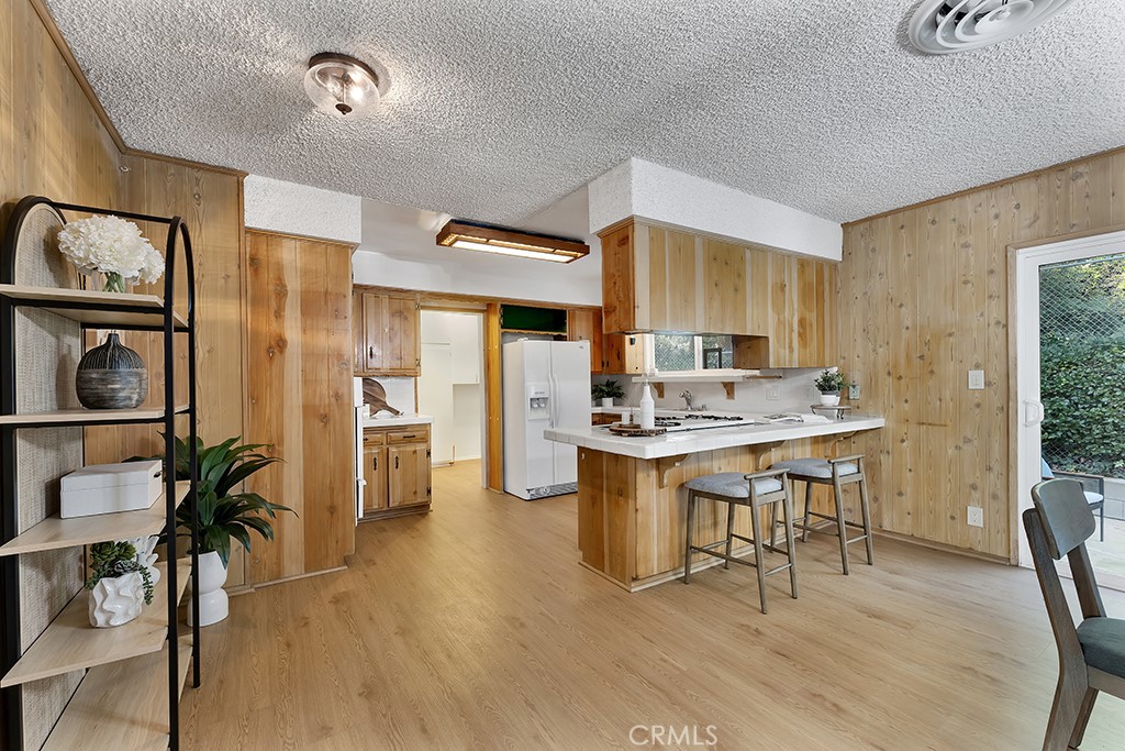 4775 Regalo Road Woodland Hills, CA 91364 - Photo 17 of 42 a view of a dining room with furniture window and wooden floor