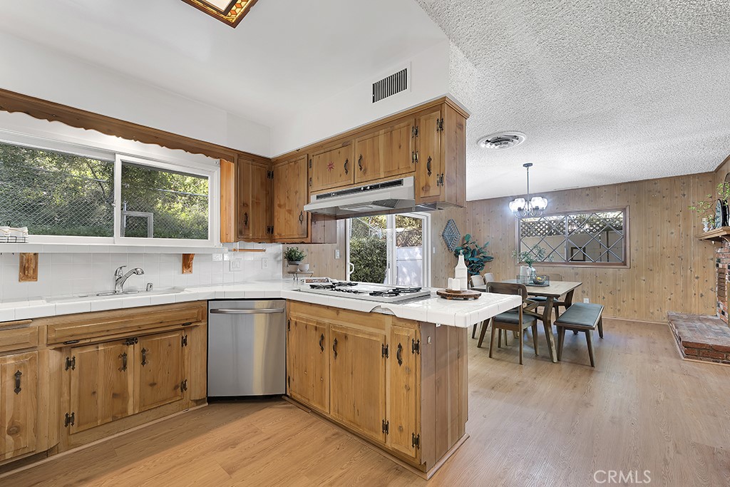 4775 Regalo Road Woodland Hills, CA 91364 - Photo 18 of 42 a kitchen with a sink stove and cabinets