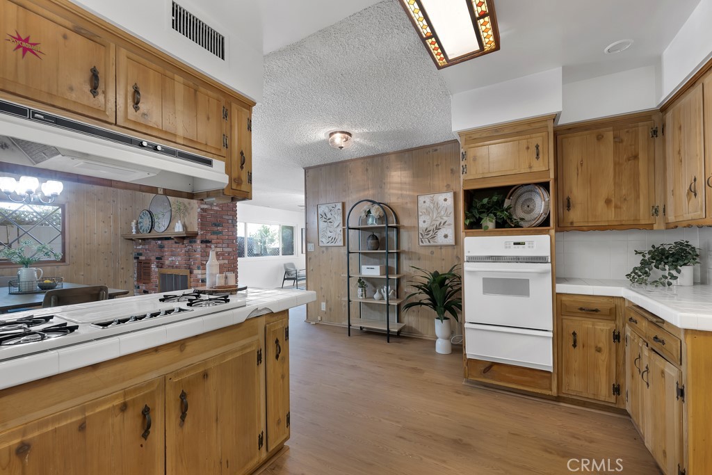 4775 Regalo Road Woodland Hills, CA 91364 - Photo 19 of 42 a kitchen with cabinets and window