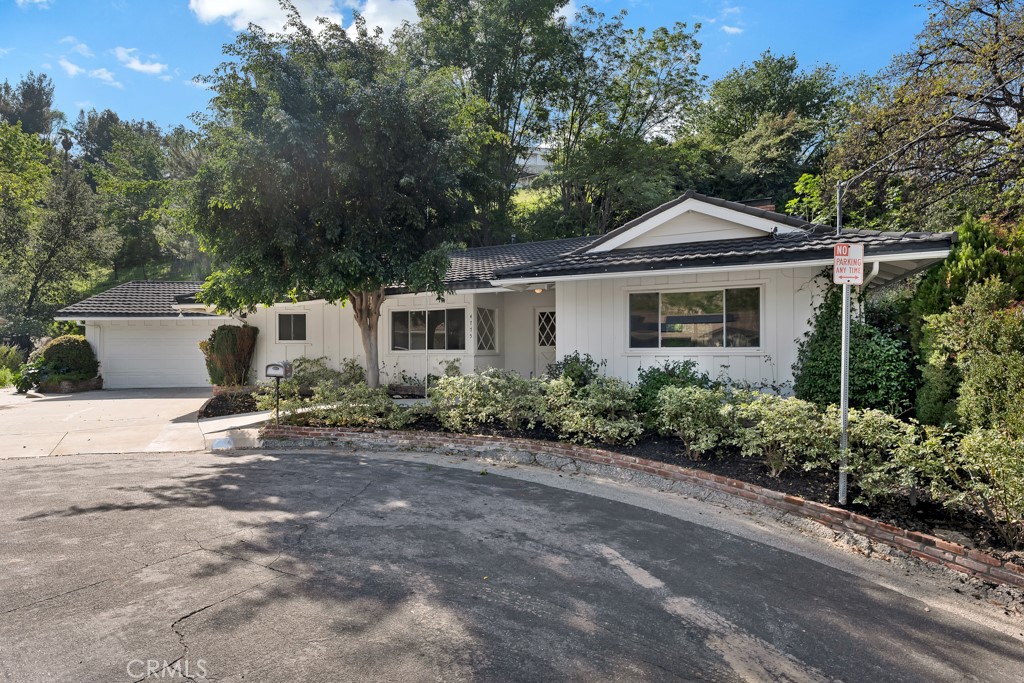 4775 Regalo Road Woodland Hills, CA 91364 - Photo 2 of 42 a front view of a house with a yard