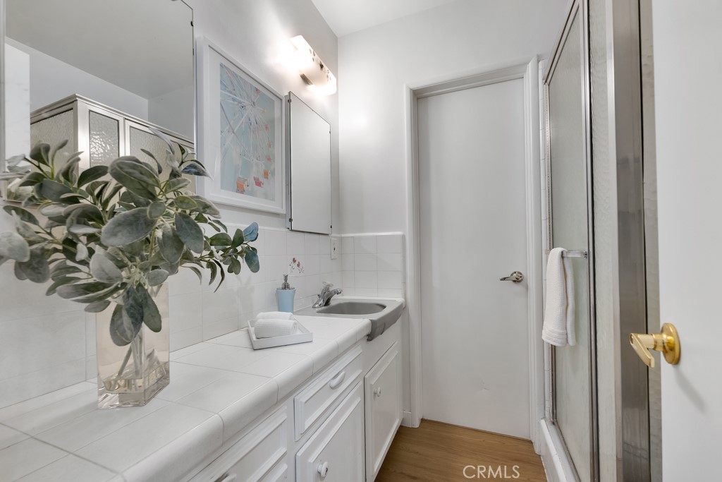 4775 Regalo Road Woodland Hills, CA 91364 - Photo 23 of 42 a bathroom with a sink a toilet and a mirror