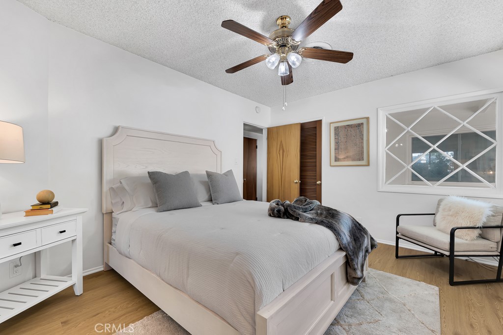 4775 Regalo Road Woodland Hills, CA 91364 - Photo 25 of 42 a bedroom with a bed and a chandelier