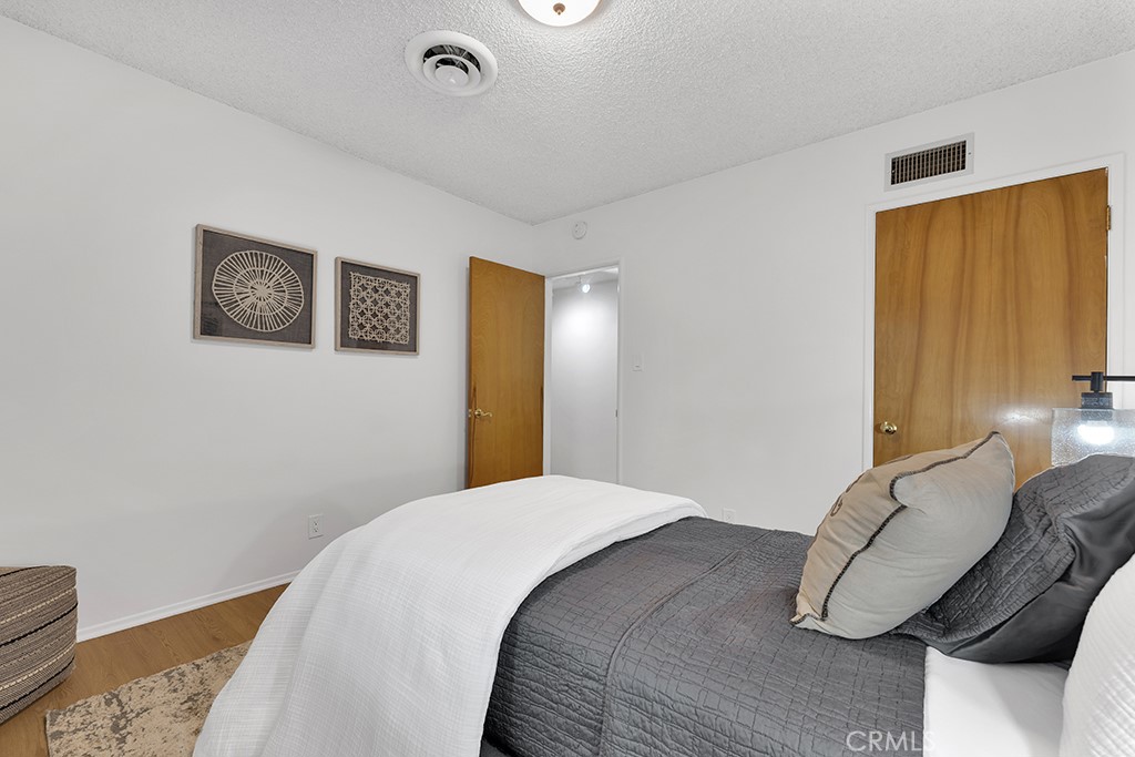 4775 Regalo Road Woodland Hills, CA 91364 - Photo 26 of 42 a bedroom with a bed and wooden floor