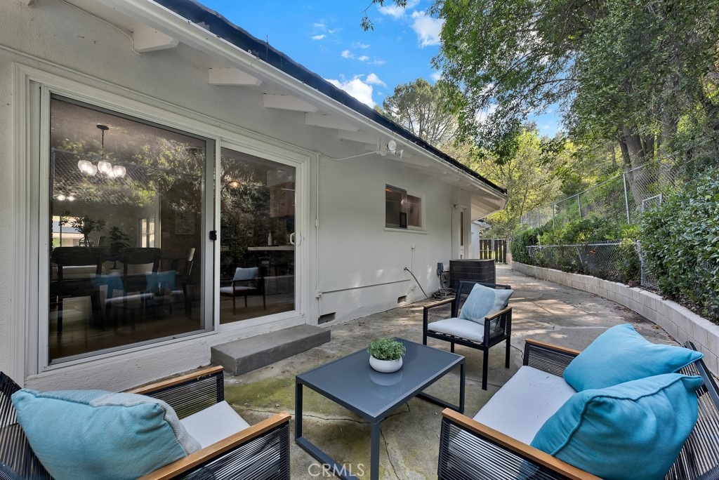 4775 Regalo Road Woodland Hills, CA 91364 - Photo 31 of 42 a view of a patio with couches table and chairs and potted plants