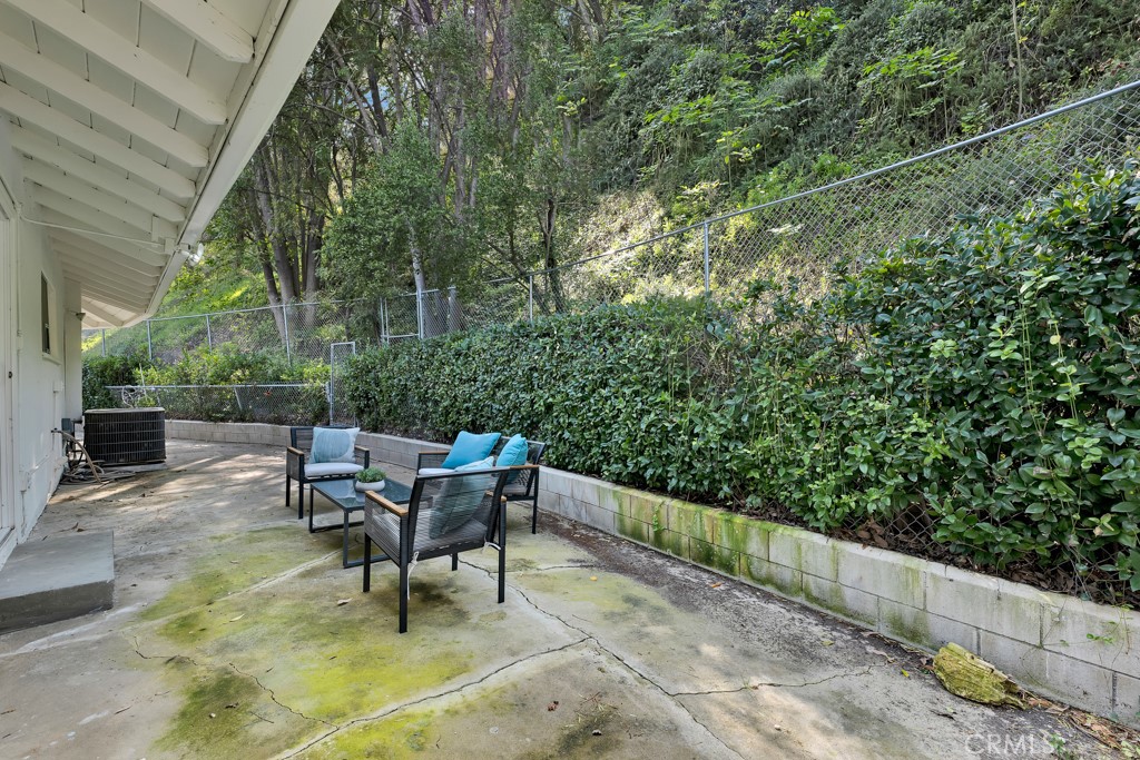 4775 Regalo Road Woodland Hills, CA 91364 - Photo 33 of 42 a backyard of a house with table and chairs