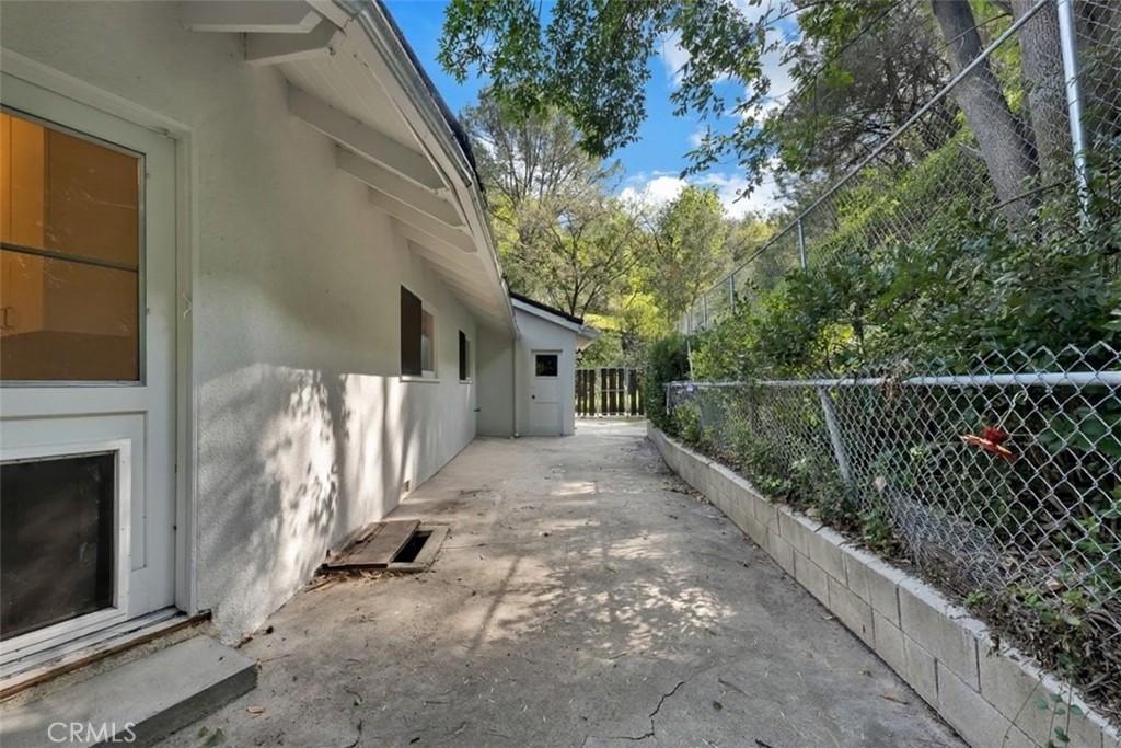 4775 Regalo Road Woodland Hills, CA 91364 - Photo 35 of 42 a view of a house with a small yard and wooden fence