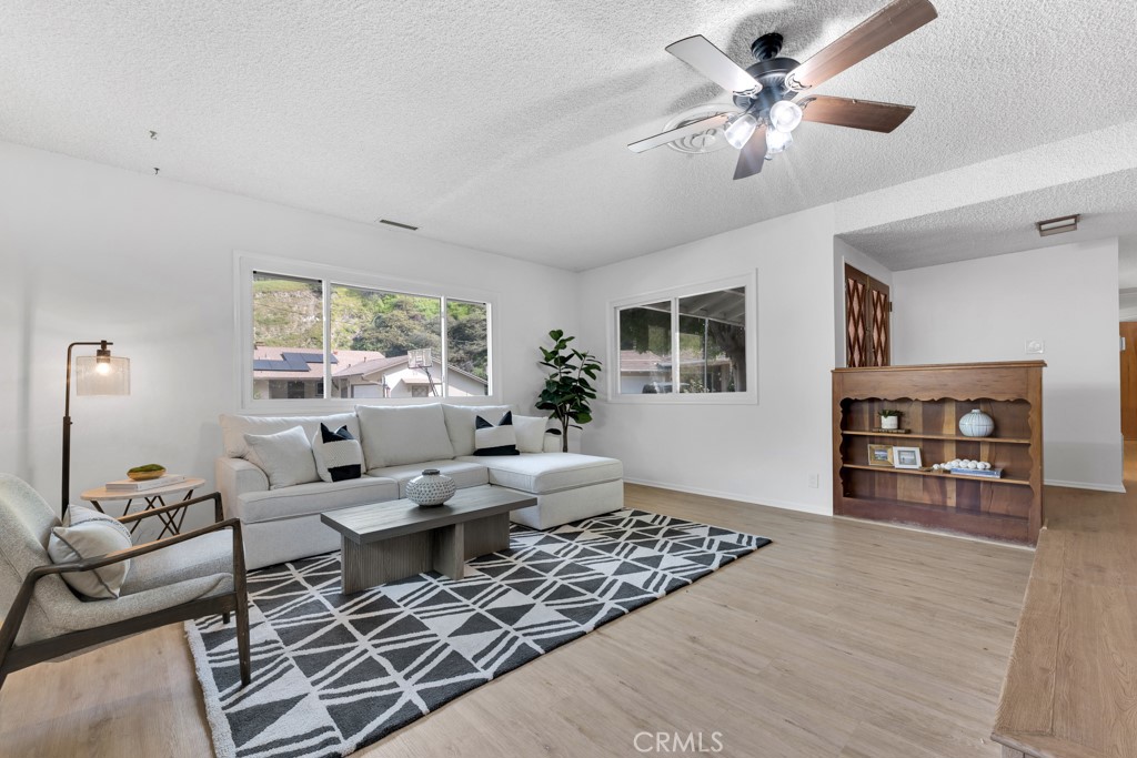 4775 Regalo Road Woodland Hills, CA 91364 - Photo 8 of 42 a living room with furniture and a large window