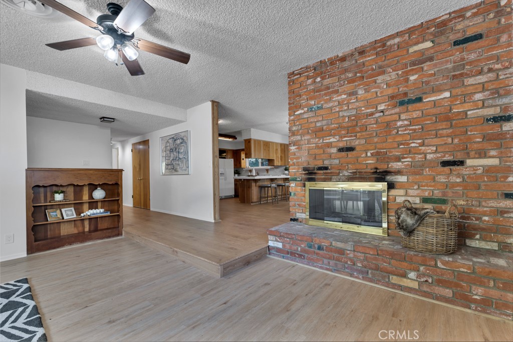 4775 Regalo Road Woodland Hills, CA 91364 - Photo 9 of 42 a living room with furniture and a fireplace