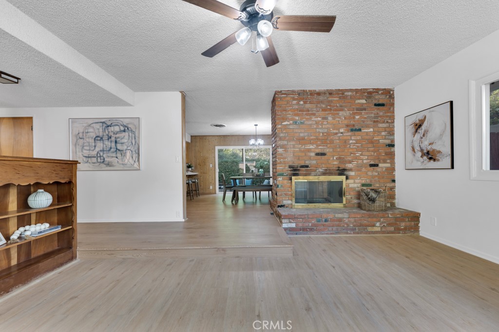 4775 Regalo Road Woodland Hills, CA 91364 - Photo 10 of 42 a living room with furniture and a fireplace