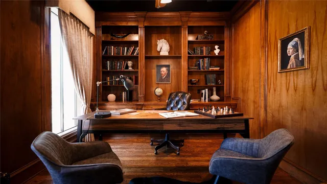a table and chairs in a room next to a window