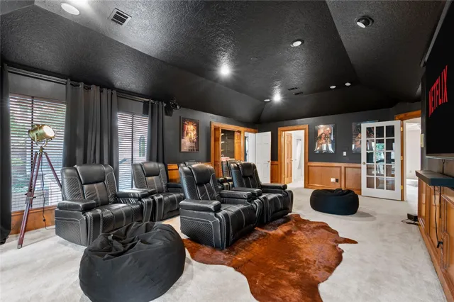 a living room with furniture a fireplace and a projector