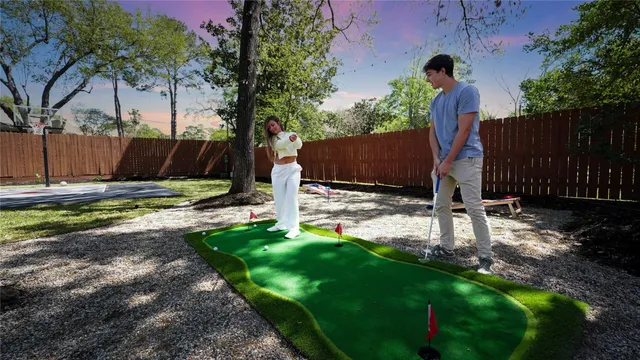 a view of a backyard with a tree
