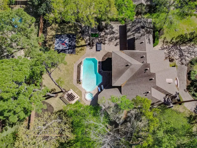 an aerial view of a house with outdoor space and street view