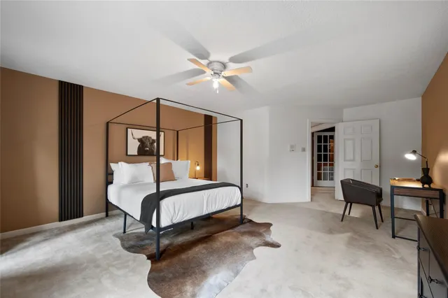 a bedroom with a bed and a potted plant