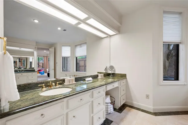 a bathroom with a sink a vanity and a mirror