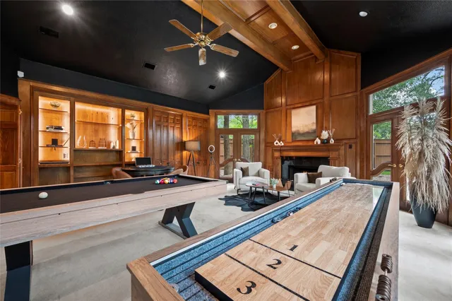 a room with furniture pool table and a large window