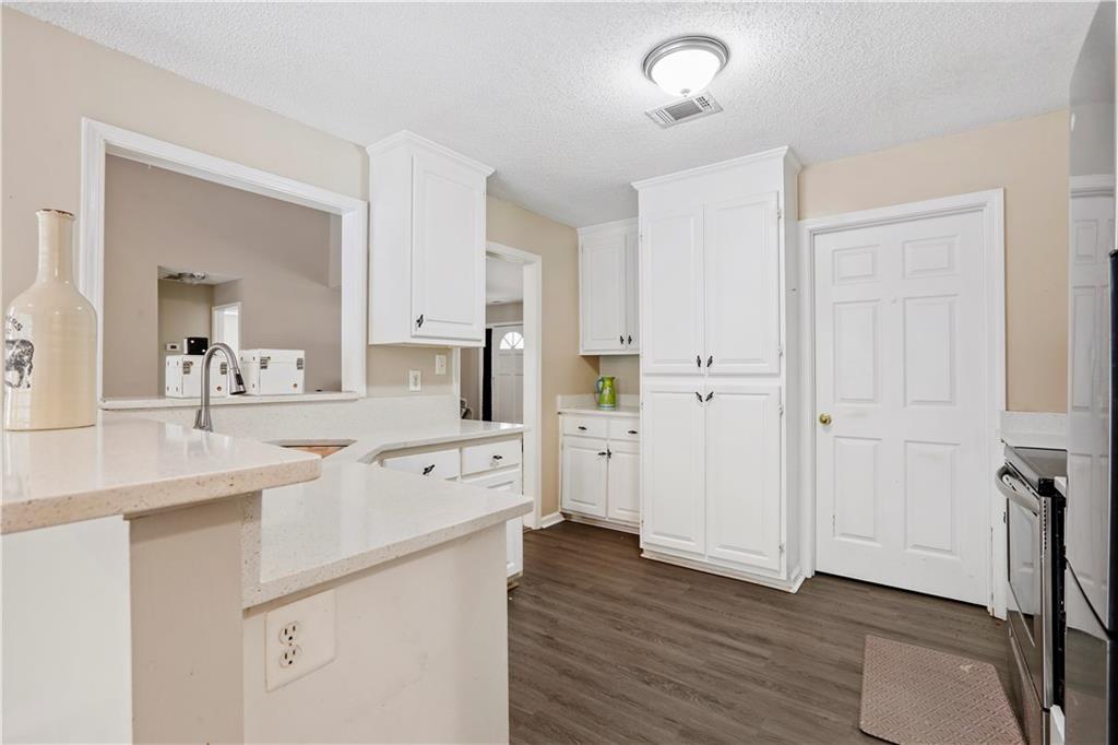 1300 Sunflower Court Locust Grove, GA 30248 - Photo 11 of 24 a large white kitchen with cabinets