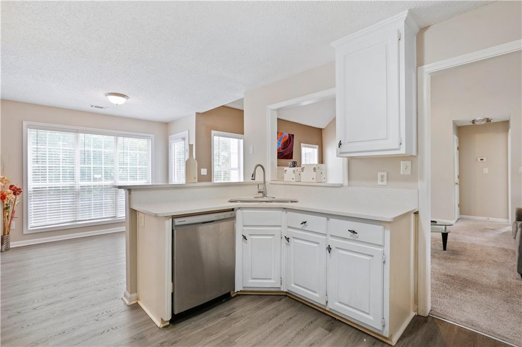 1300 Sunflower Court Locust Grove, GA 30248 - Photo 12 of 24 a kitchen with white cabinets and sink