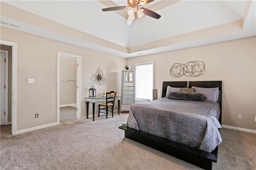 1300 Sunflower Court Locust Grove, GA 30248 - Photo 13 of 24 a bedroom with a bed chandelier and a window