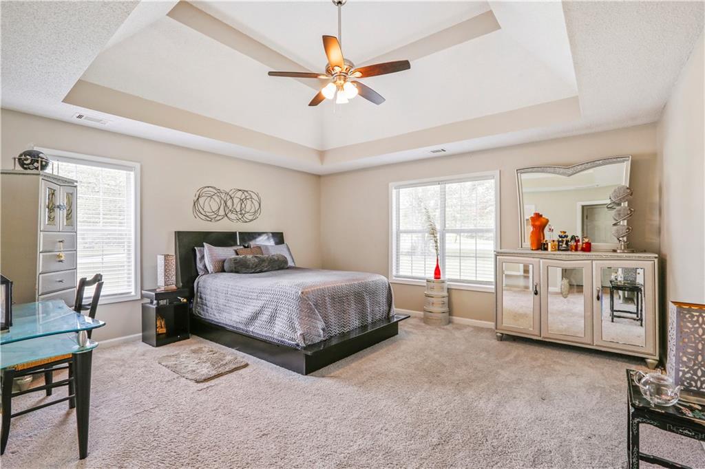 1300 Sunflower Court Locust Grove, GA 30248 - Photo 14 of 24 a bedroom with a bed a window and dresser
