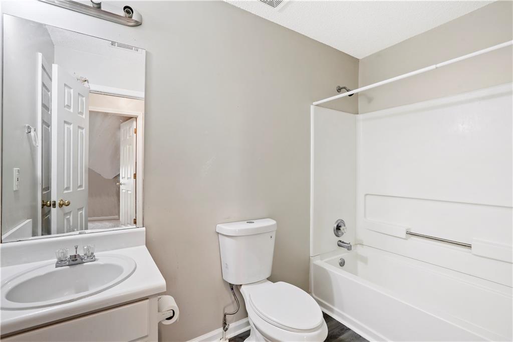 1300 Sunflower Court Locust Grove, GA 30248 - Photo 15 of 24 a bathroom with a sink a toilet and shower