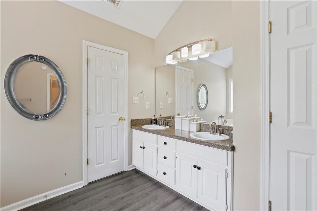 1300 Sunflower Court Locust Grove, GA 30248 - Photo 18 of 24 a bathroom with a double vanity sink and a mirror