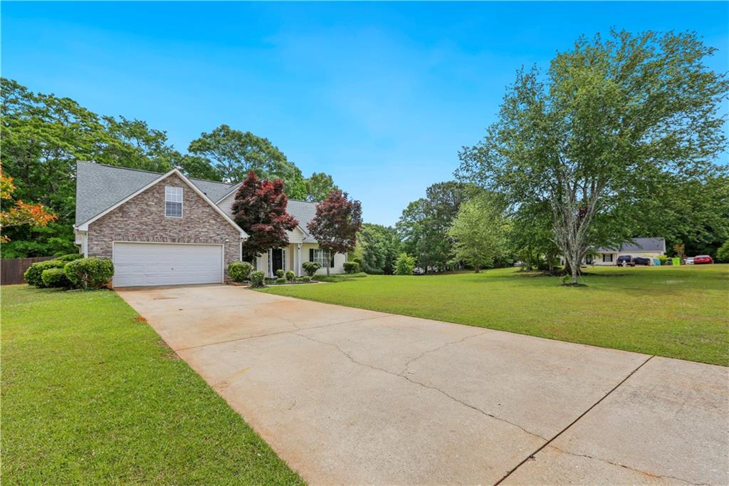 1300 Sunflower Court Locust Grove, GA 30248 - Photo 2 of 24 a front view of house with yard and green space