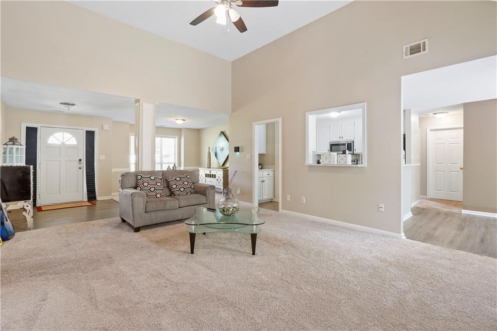 1300 Sunflower Court Locust Grove, GA 30248 - Photo 4 of 24 a living room with furniture and a lamp