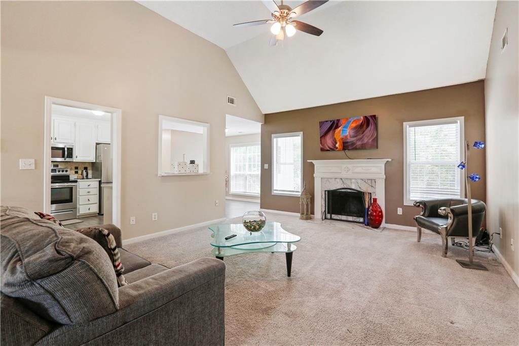 1300 Sunflower Court Locust Grove, GA 30248 - Photo 6 of 24 a living room with furniture and a fireplace