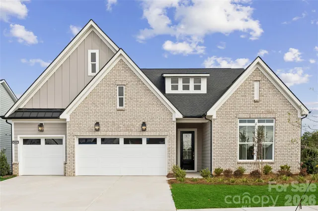a view of a white house next to a yard