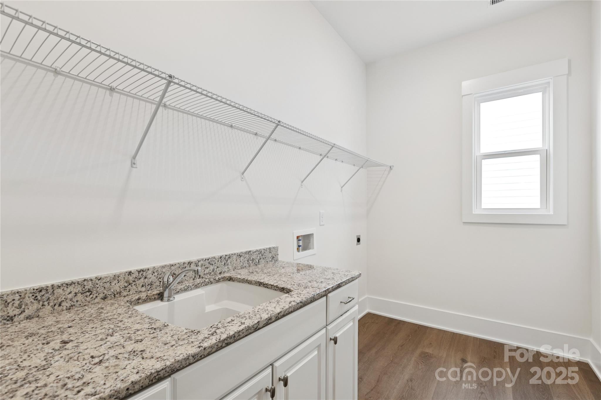 4334 Durango Drive, Unit 265 Indian Land, SC 29707 - Photo 11 of 28 a bathroom with a granite countertop sink and vanity