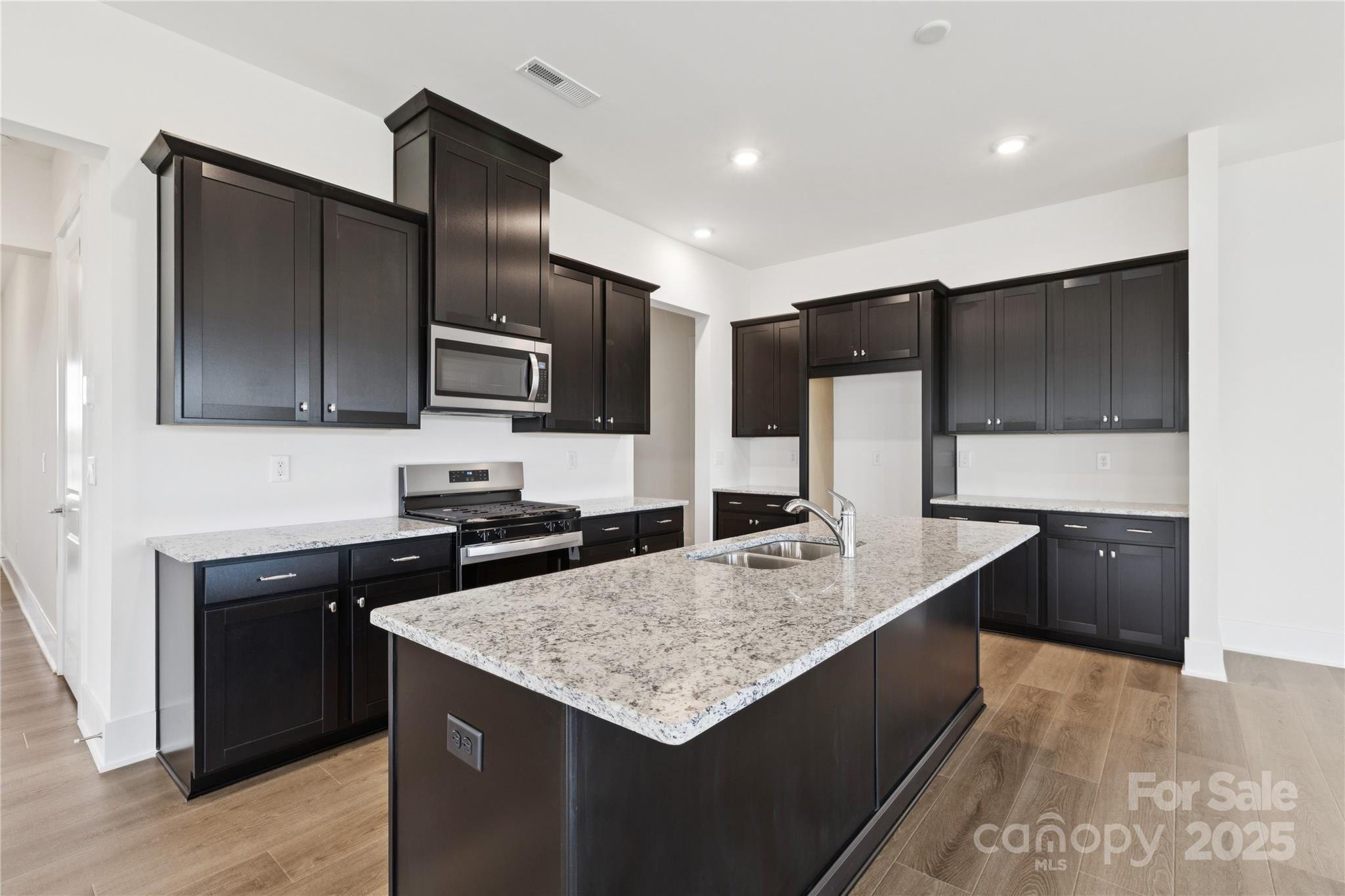 4334 Durango Drive, Unit 265 Indian Land, SC 29707 - Photo 2 of 28 a kitchen with stainless steel appliances granite countertop a sink a stove and refrigerator