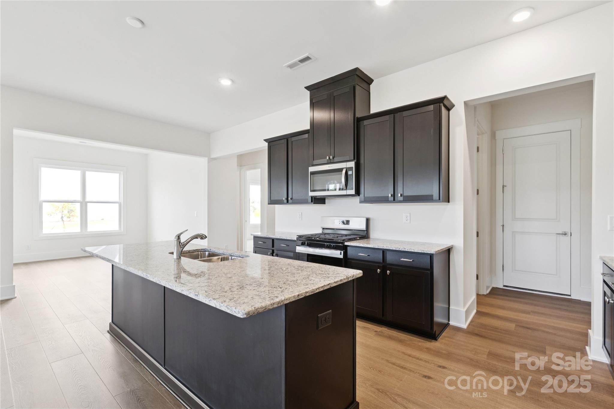 4334 Durango Drive, Unit 265 Indian Land, SC 29707 - Photo 3 of 28 a kitchen with stainless steel appliances granite countertop a sink stove and refrigerator