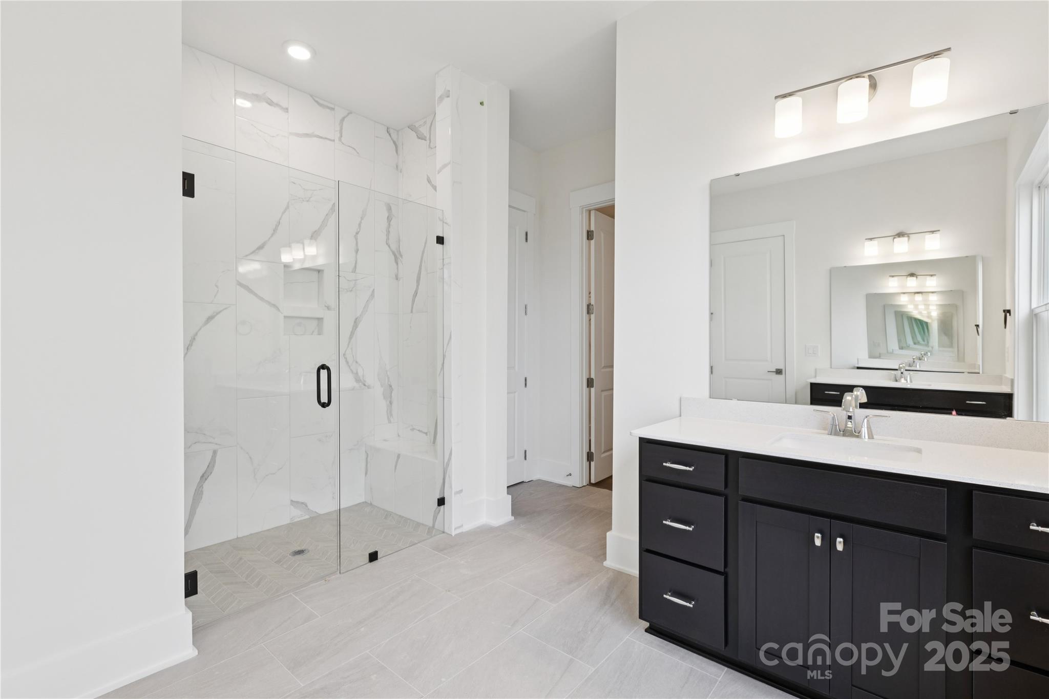 4334 Durango Drive, Unit 265 Indian Land, SC 29707 - Photo 5 of 28 a bathroom with a double vanity sink mirror and shower