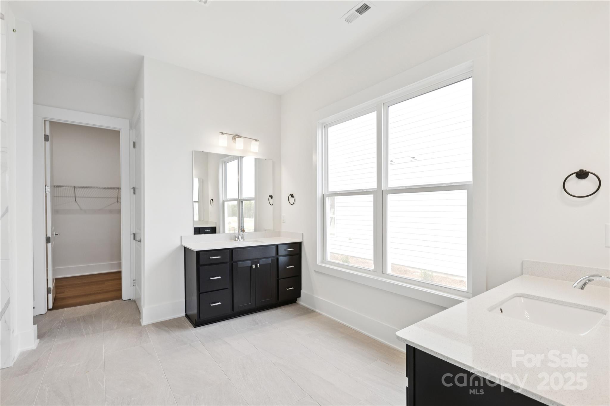 4334 Durango Drive, Unit 265 Indian Land, SC 29707 - Photo 6 of 28 a spacious bathroom with a granite countertop sink and a bathtub