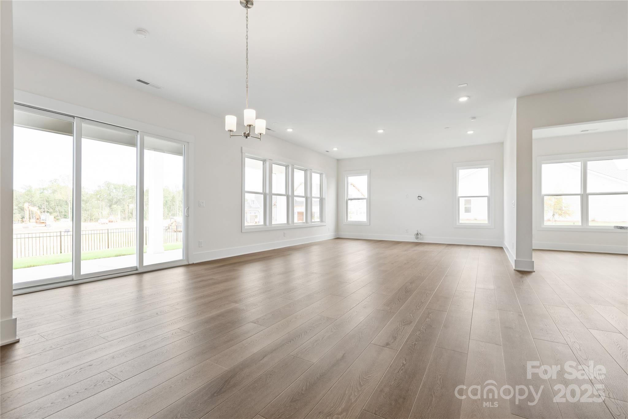 4334 Durango Drive, Unit 265 Indian Land, SC 29707 - Photo 7 of 28 a view of an empty room with wooden floor and a window