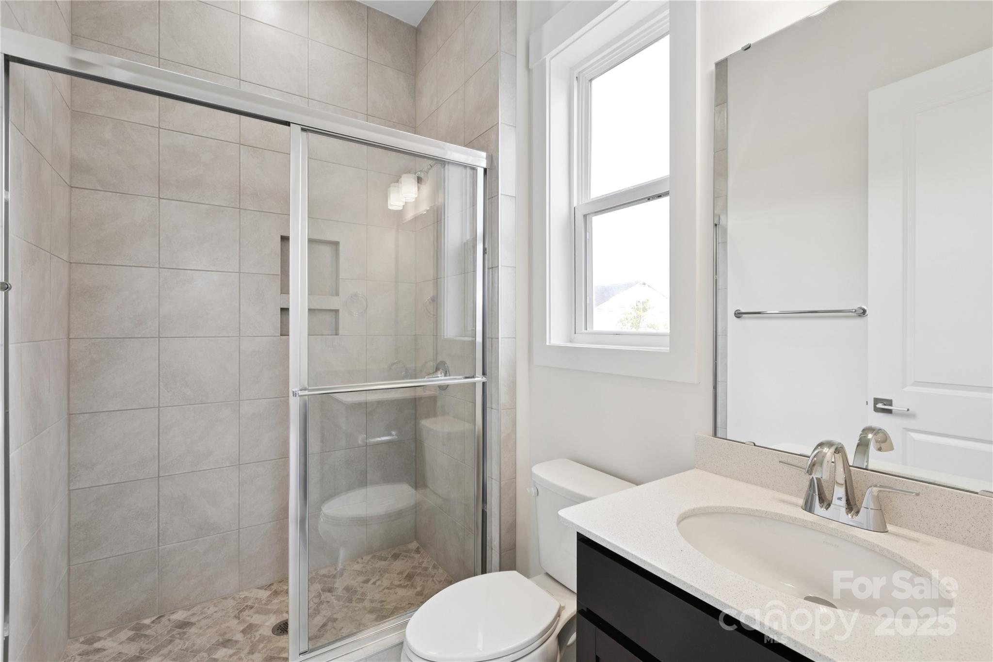 4334 Durango Drive, Unit 265 Indian Land, SC 29707 - Photo 8 of 28 a bathroom with a sink toilet a mirror and shower
