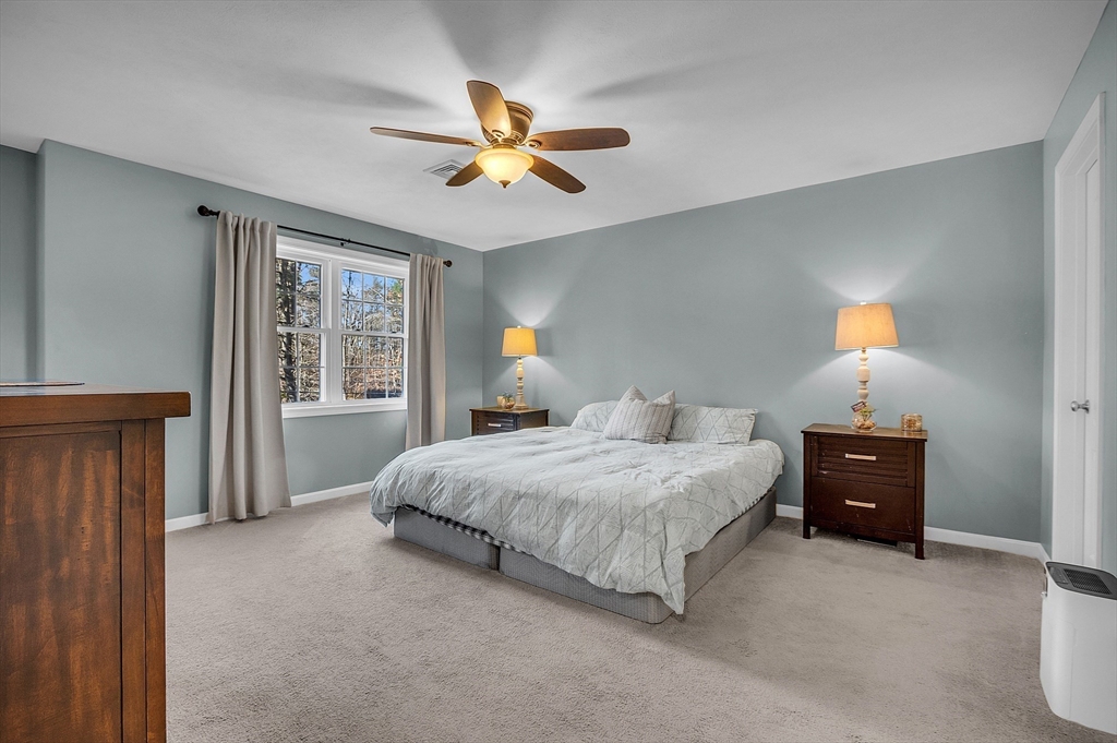 261 Bean Porridge Hill Road Westminster, MA 01473 - Photo 22 of 33 a bedroom with a bed and a chandelier